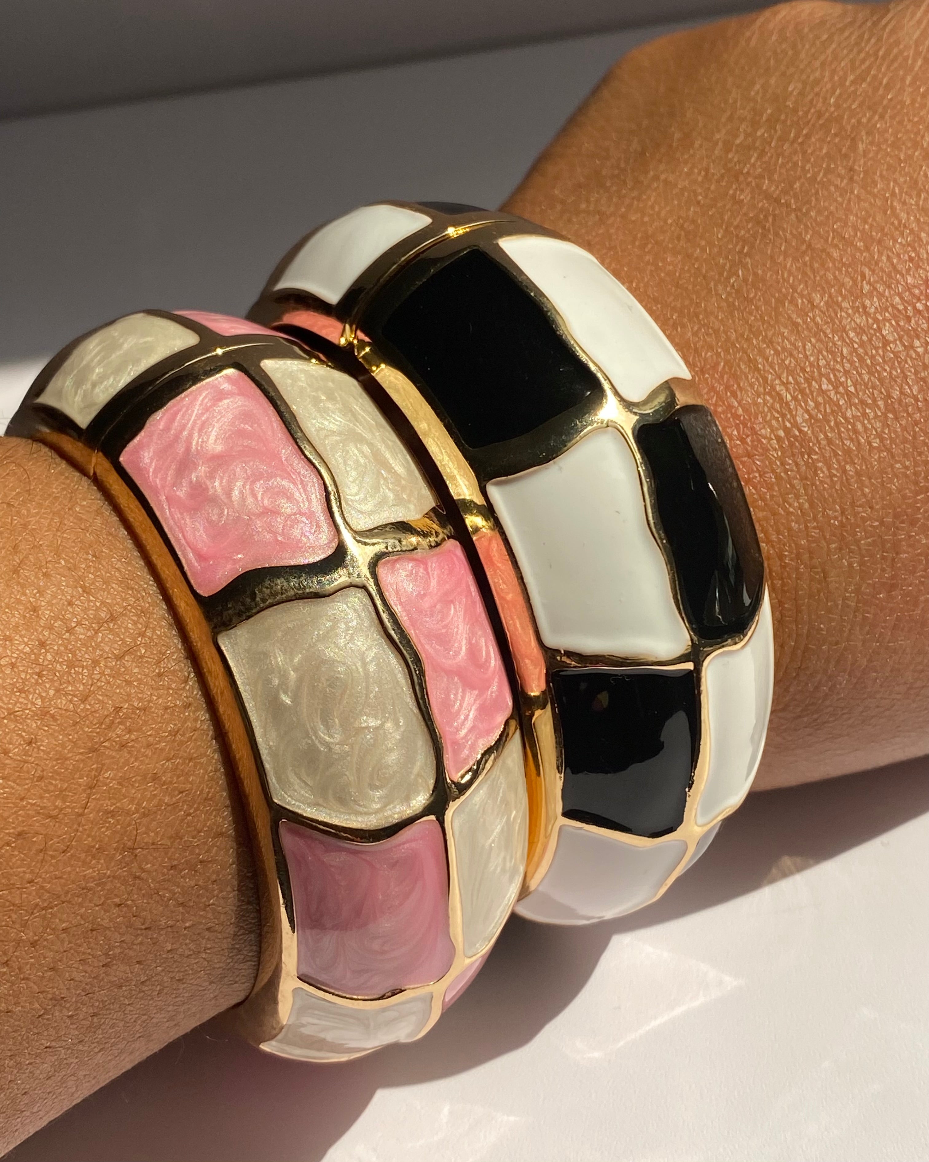 Wide gold-tone cuff bracelet featuring glossy enamel mosaic panels available in Black & Ivory and Blush Mosaic colorways.