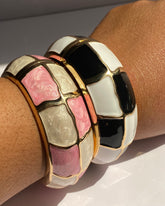 Wide gold-tone cuff bracelet featuring glossy enamel mosaic panels available in Black & Ivory and Blush Mosaic colorways.