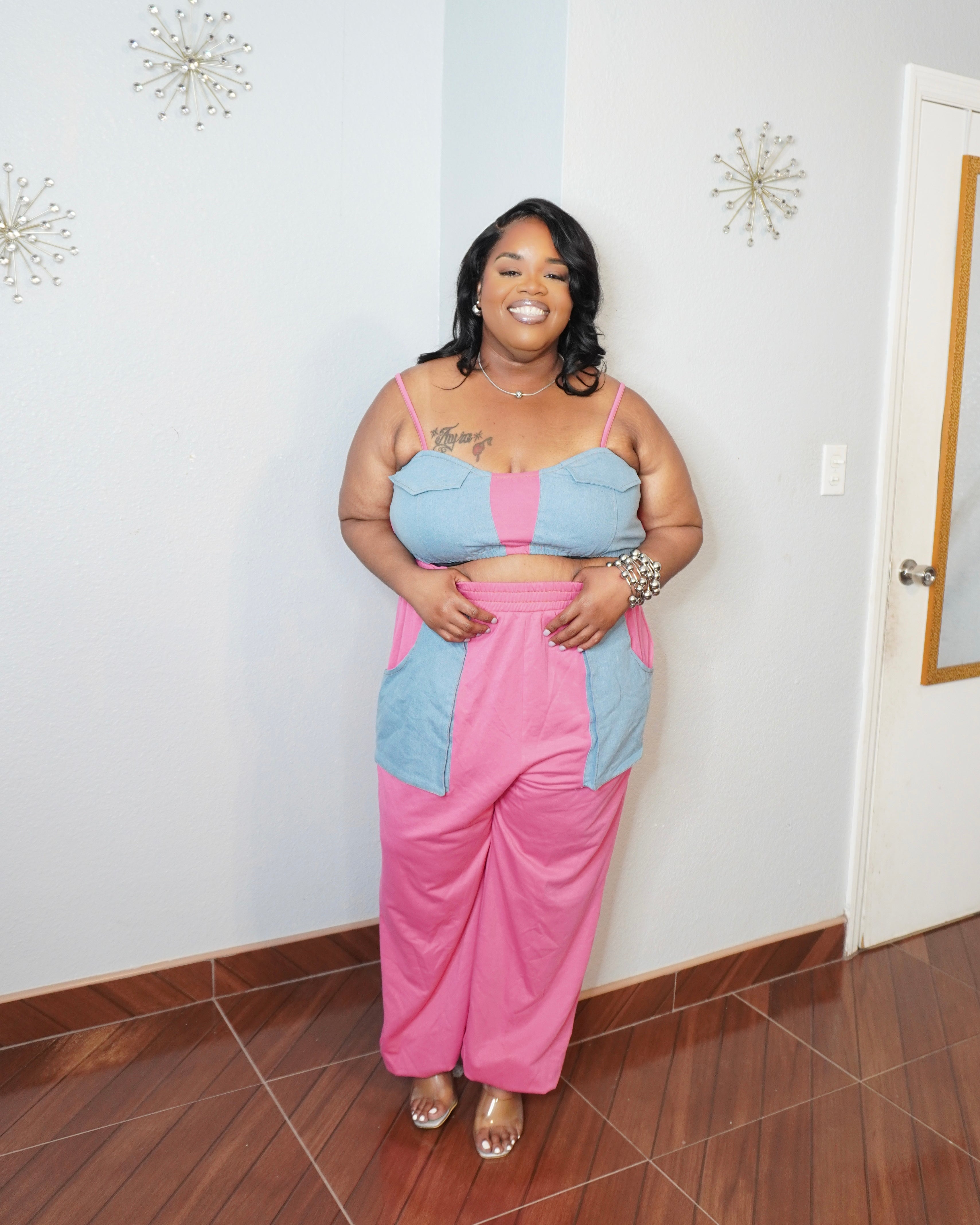 Plus size model wearing pink and blue two piece pant set front view