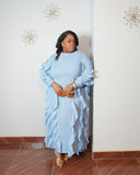 Side view of sky blue pleated ruffle maxi dress showing flowing silhouette and dramatic ruffle details.