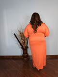 Side view of plus size coral midi dress with adjustable waist tie and flattering silhouette
