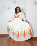 Plus size model wearing tropical pleated maxi dress with flowing silhouette