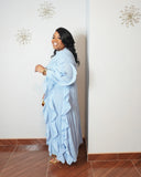 Front view of elegant sky blue pleated maxi dress with long sleeves and cascading ruffles.