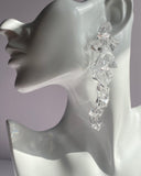 Crystal clear waterfall statement earrings featuring cascading faceted acrylic stones that create an elegant, light-catching drop design.