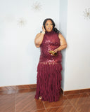 Back view of burgundy sequin evening gown with flowing chiffon layered skirt