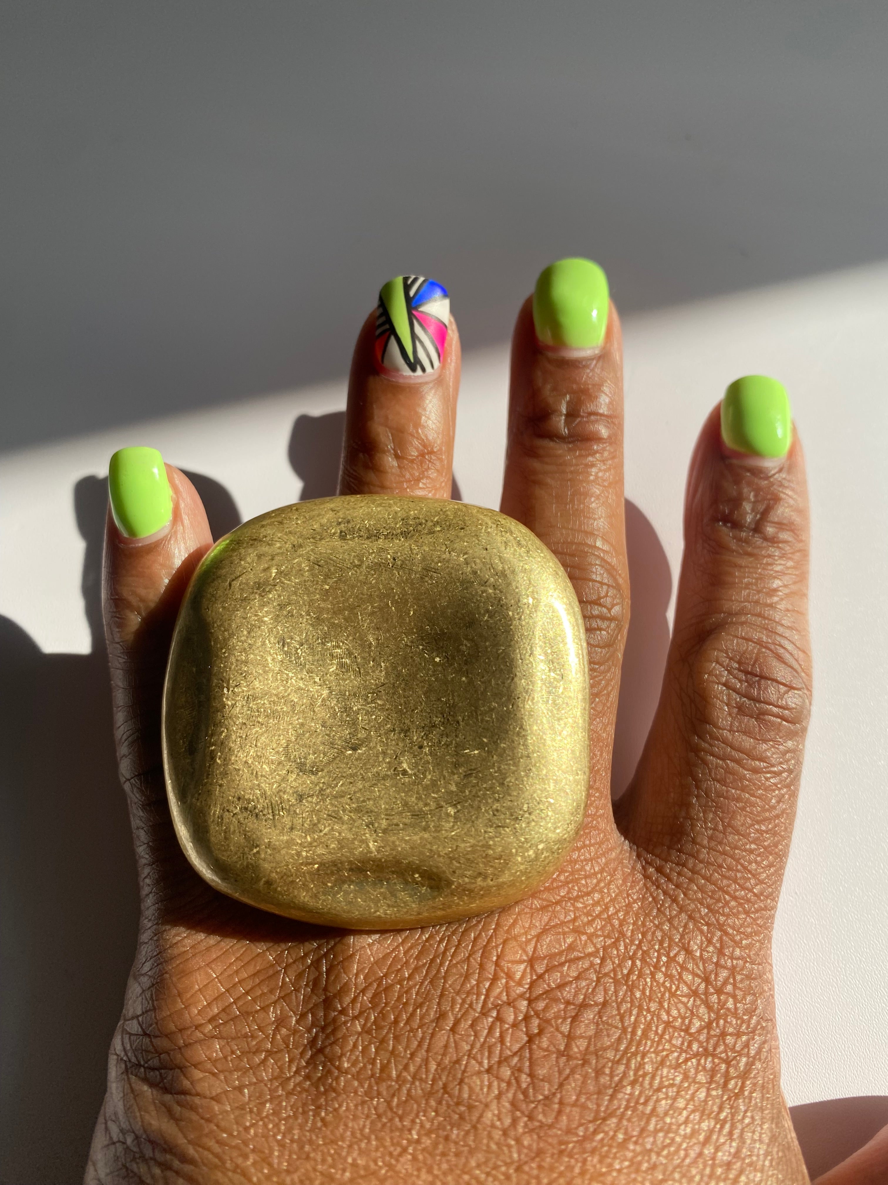 Oversized brushed gold statement ring with a modern sculptural design.