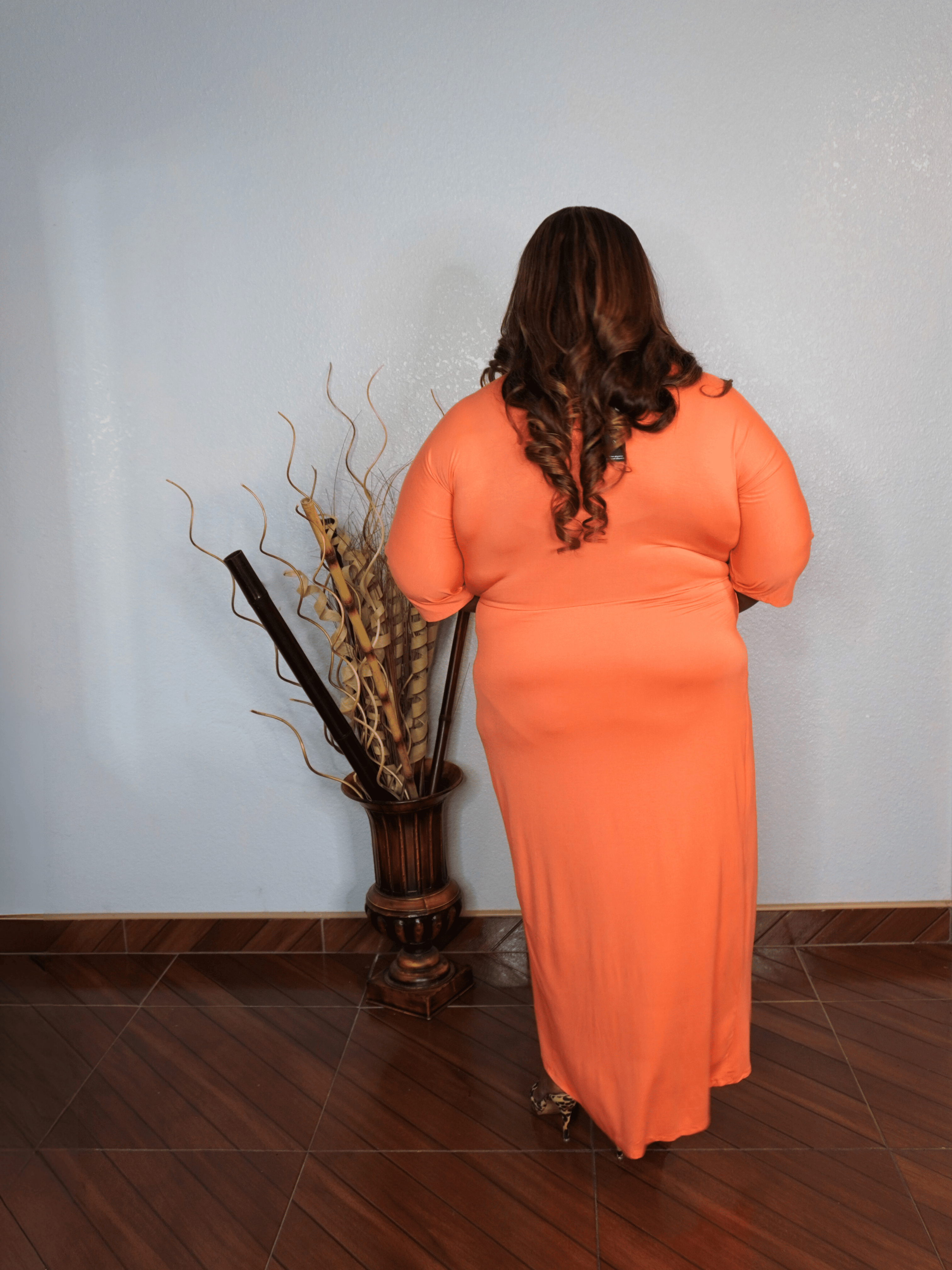 Side view of plus size coral midi dress with adjustable waist tie and flattering silhouette