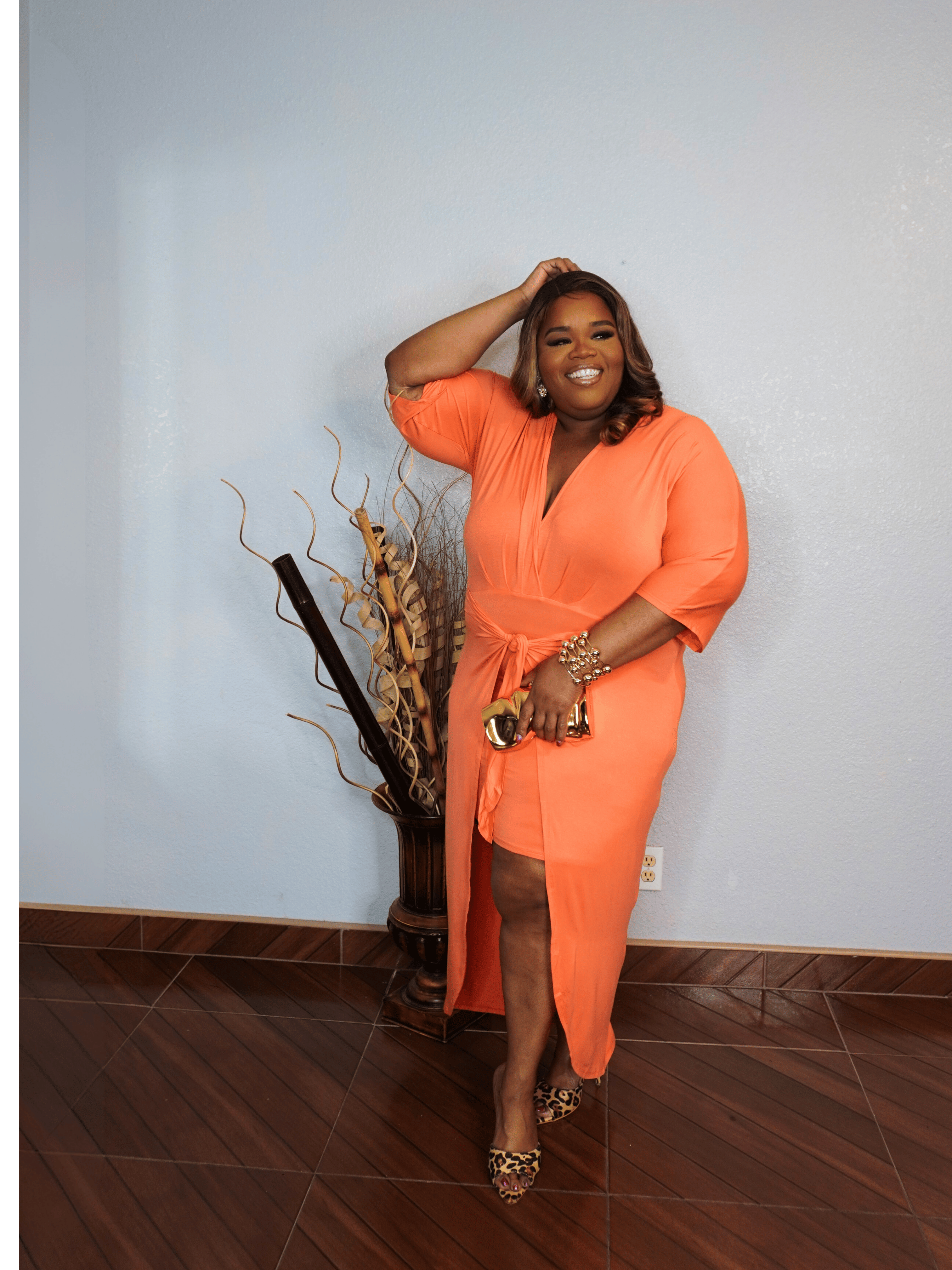 Side view of plus size coral midi dress with adjustable waist tie and flattering silhouette