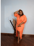 Side view of plus size coral midi dress with adjustable waist tie and flattering silhouette