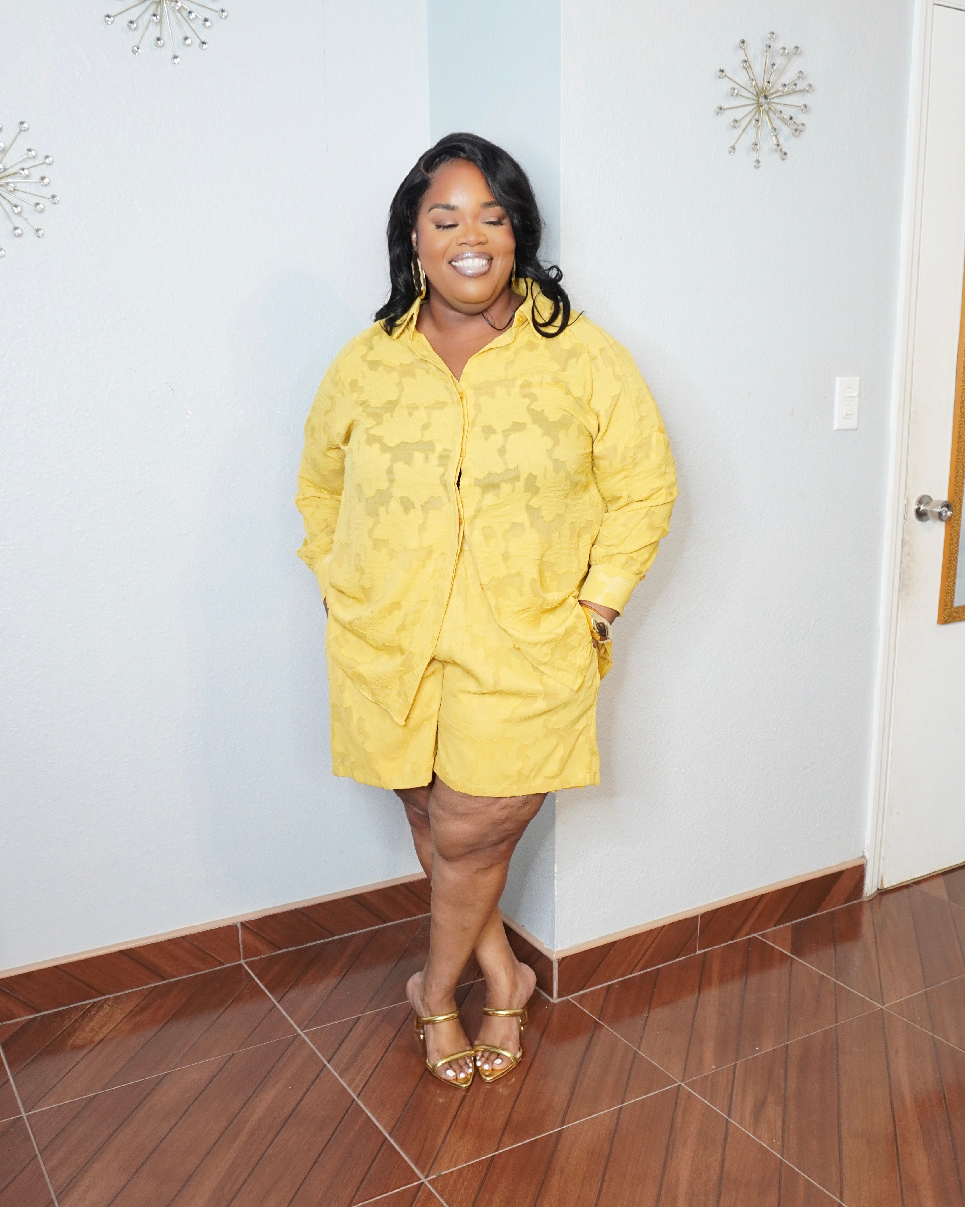 Smiling plus size model in luxury yellow matching set