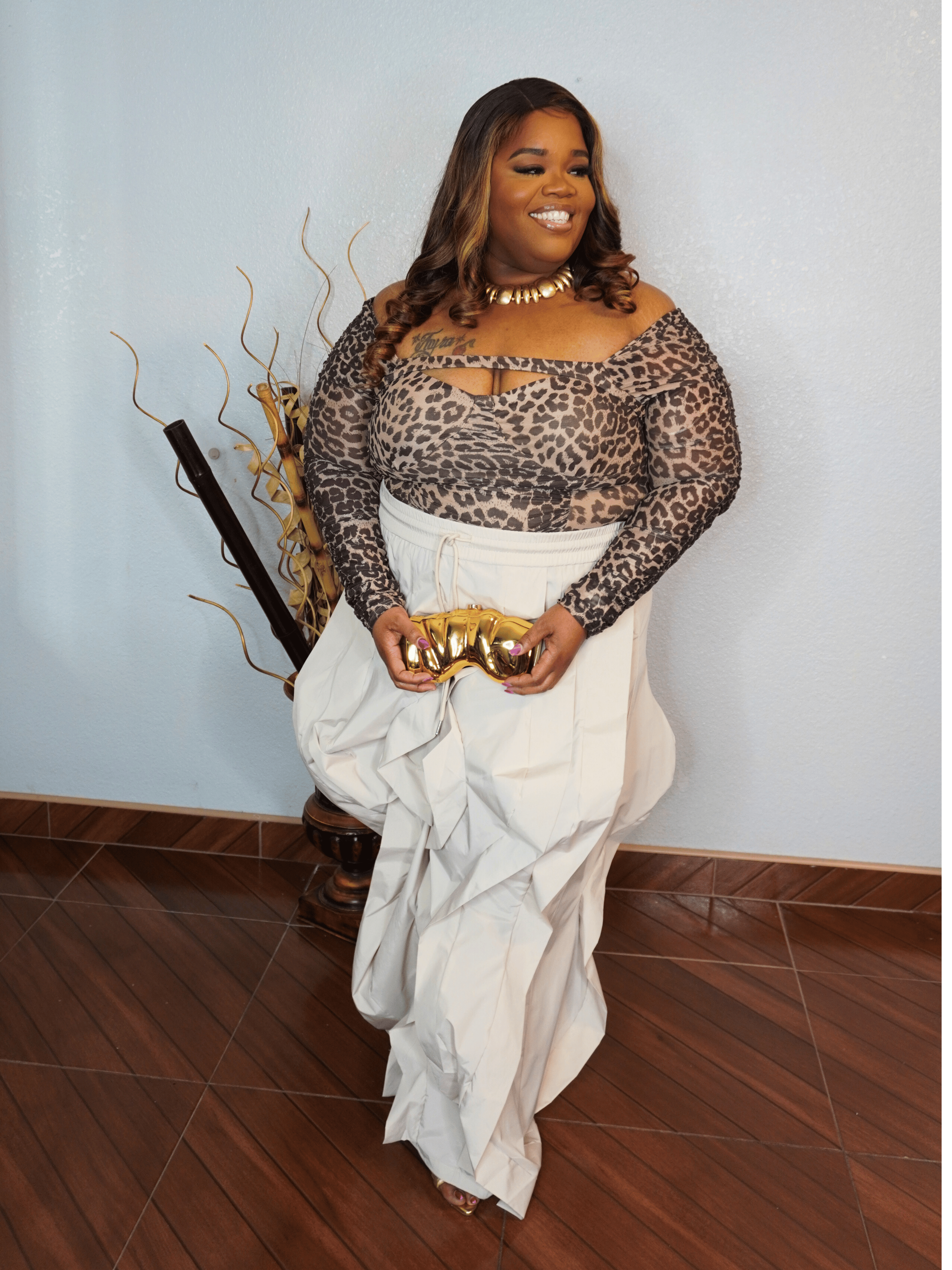 Leopard keyhole long sleeve stretch top front view for plus size women styled with statement wide leg pants