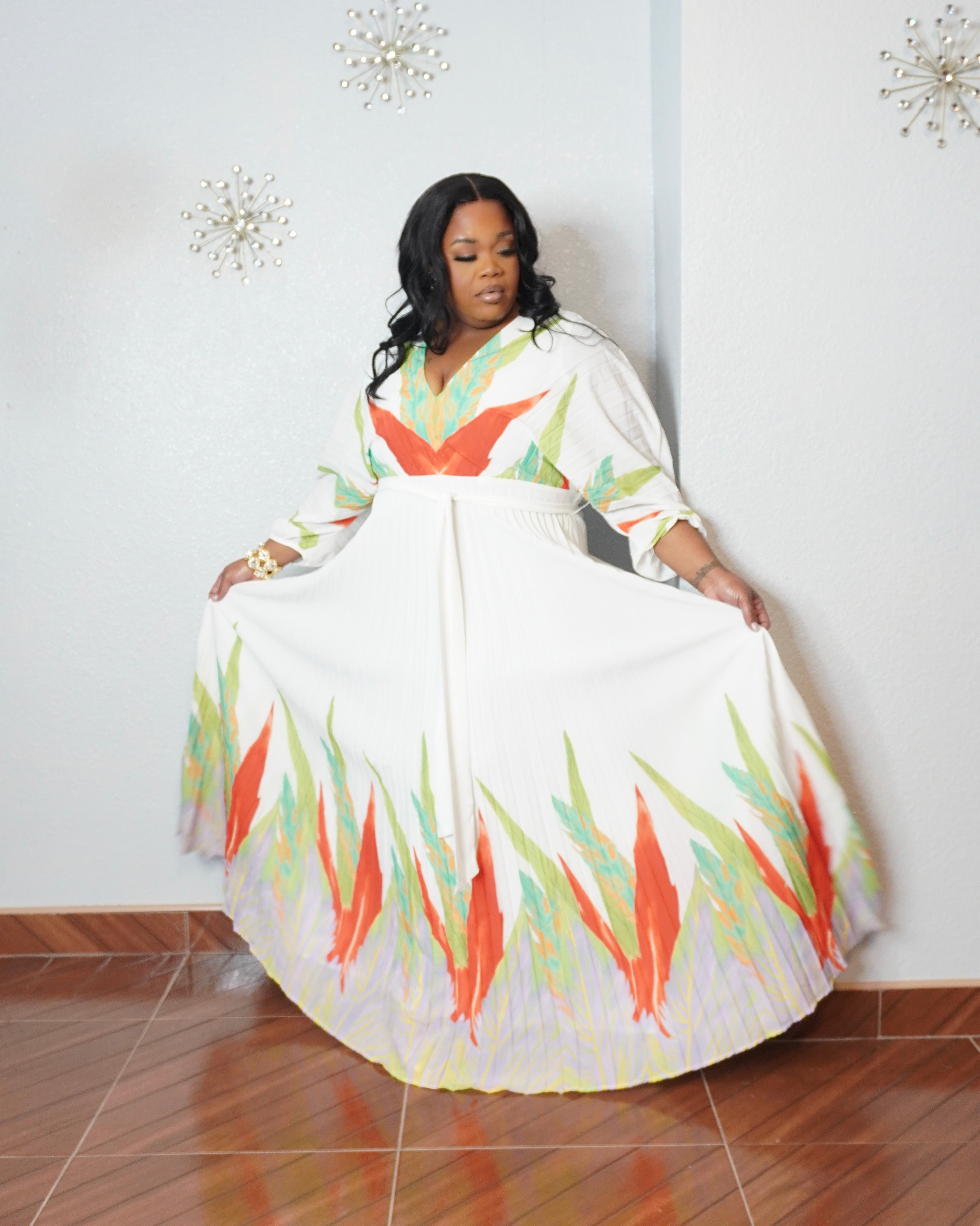 Plus size model wearing tropical pleated maxi dress with flowing silhouette