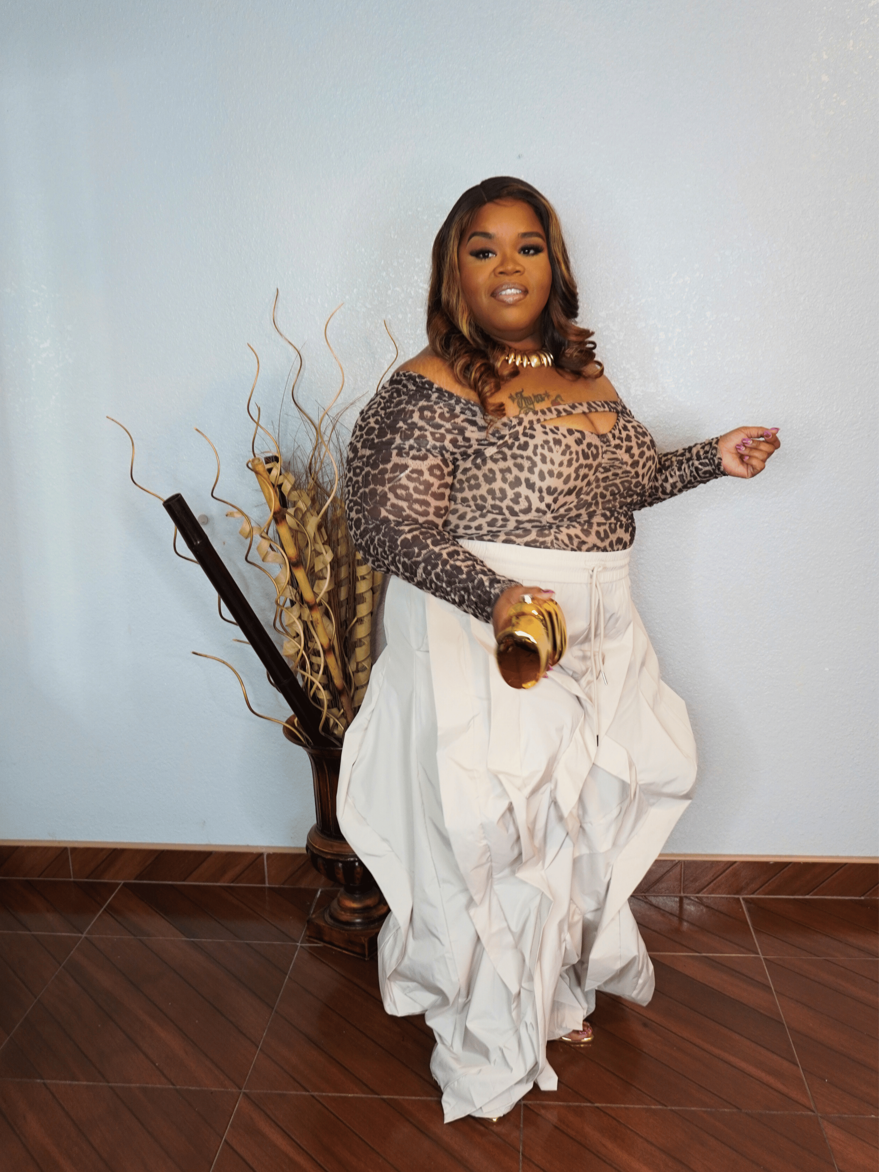 Leopard keyhole long sleeve stretch top side view for plus size women styled with statement wide leg pants
