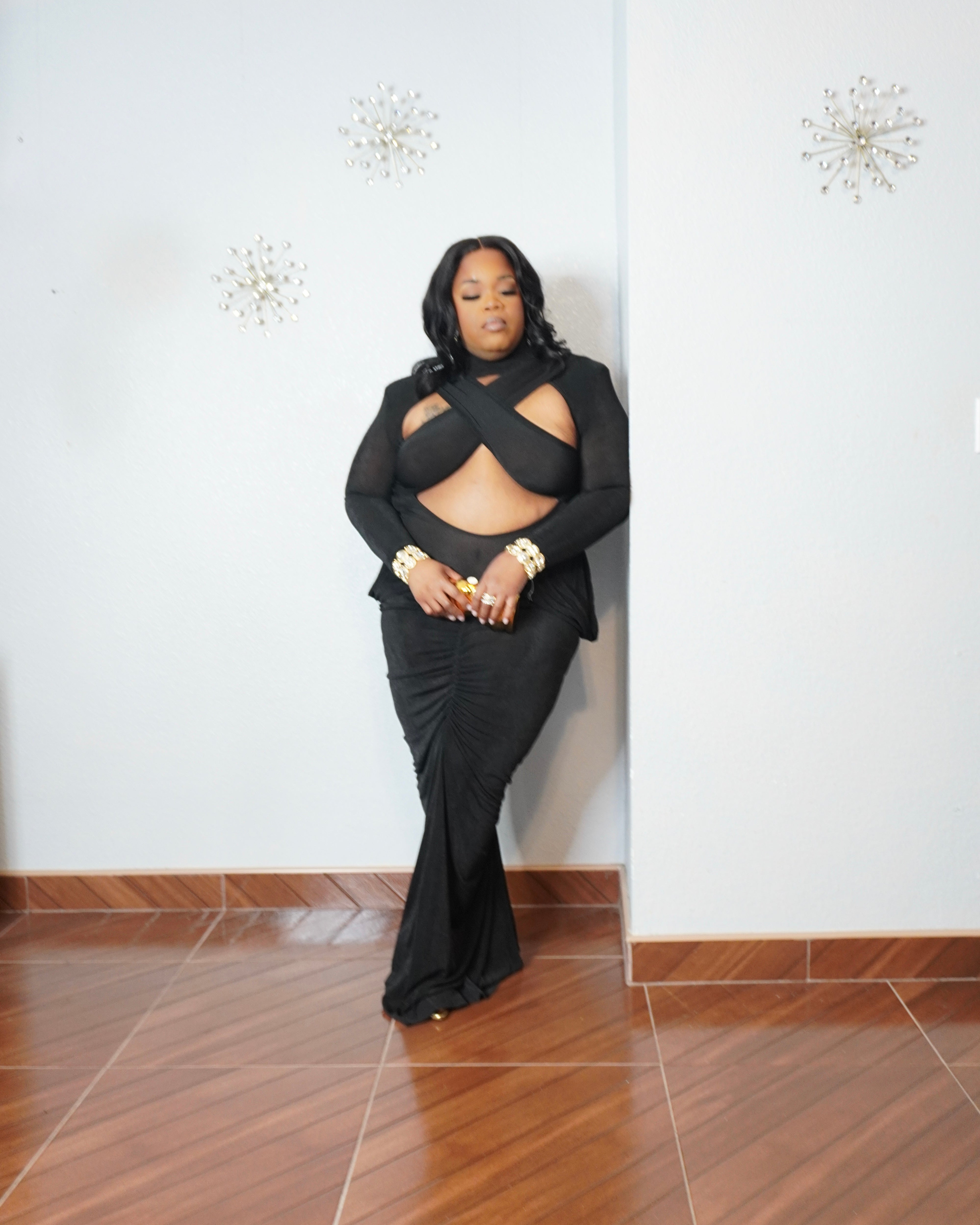 Plus size bodycon gown styled with gold accessories