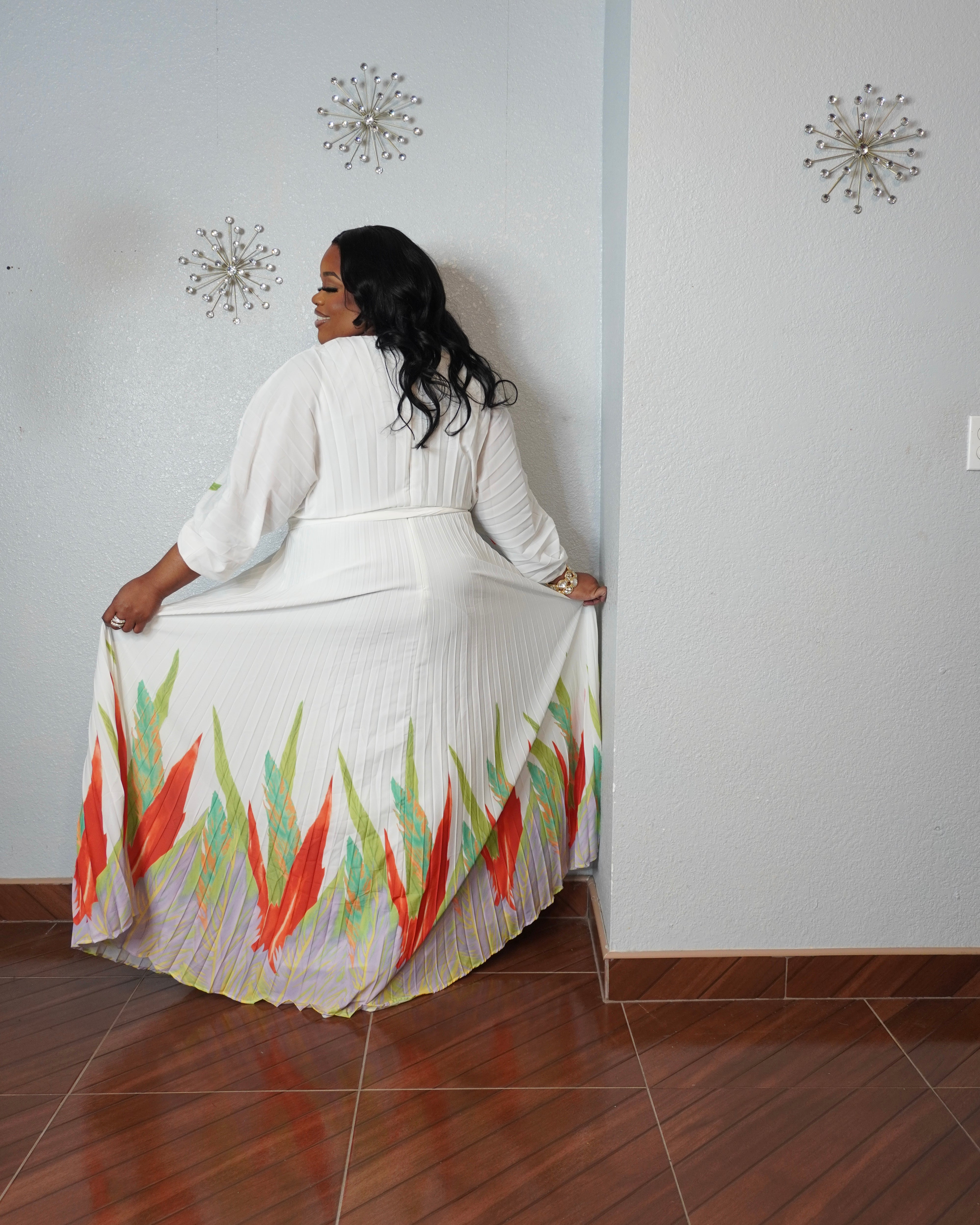 Back view of tropical pleated maxi dress with flowy silhouette