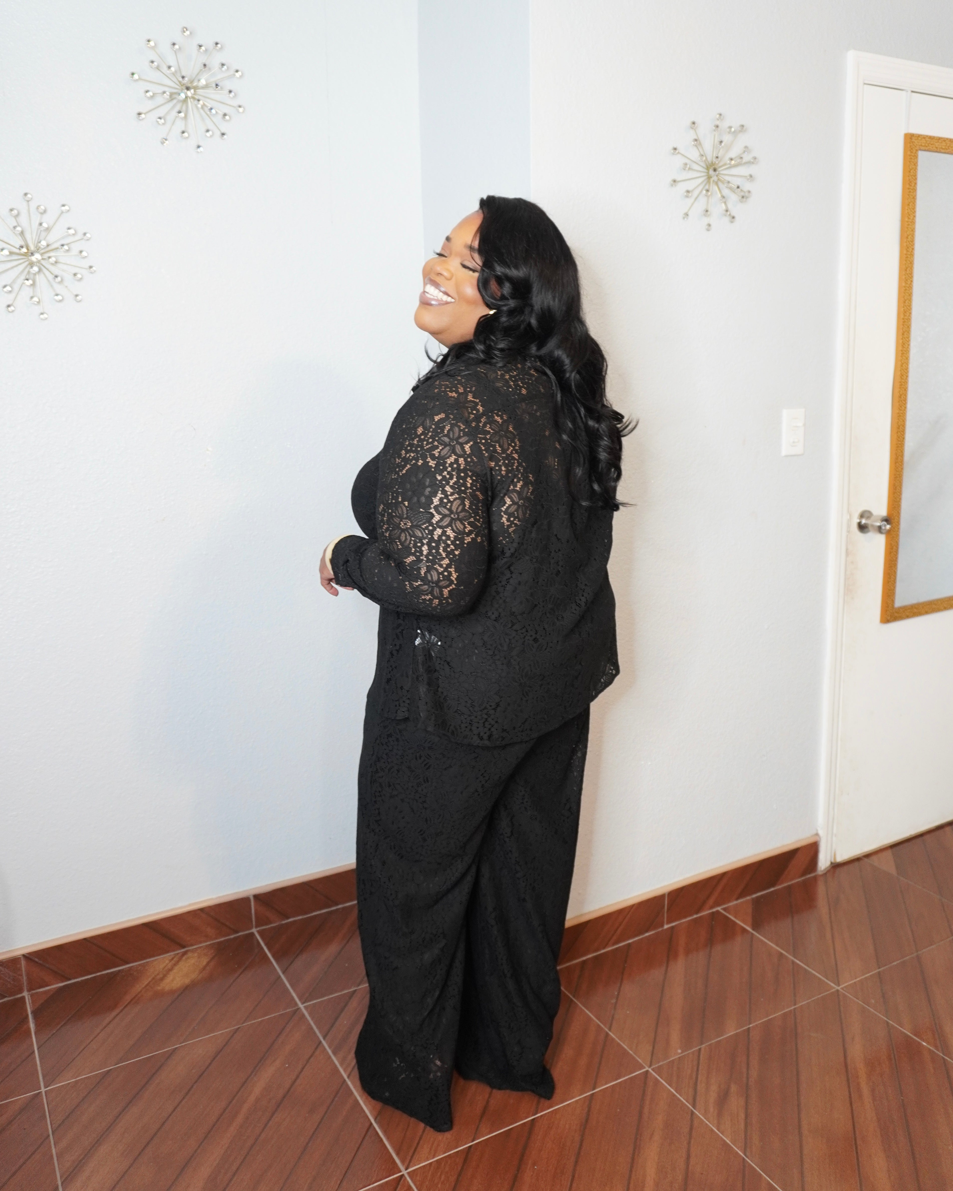 Back view of plus size black lace two-piece set showing fit of wide-leg pants and lace top