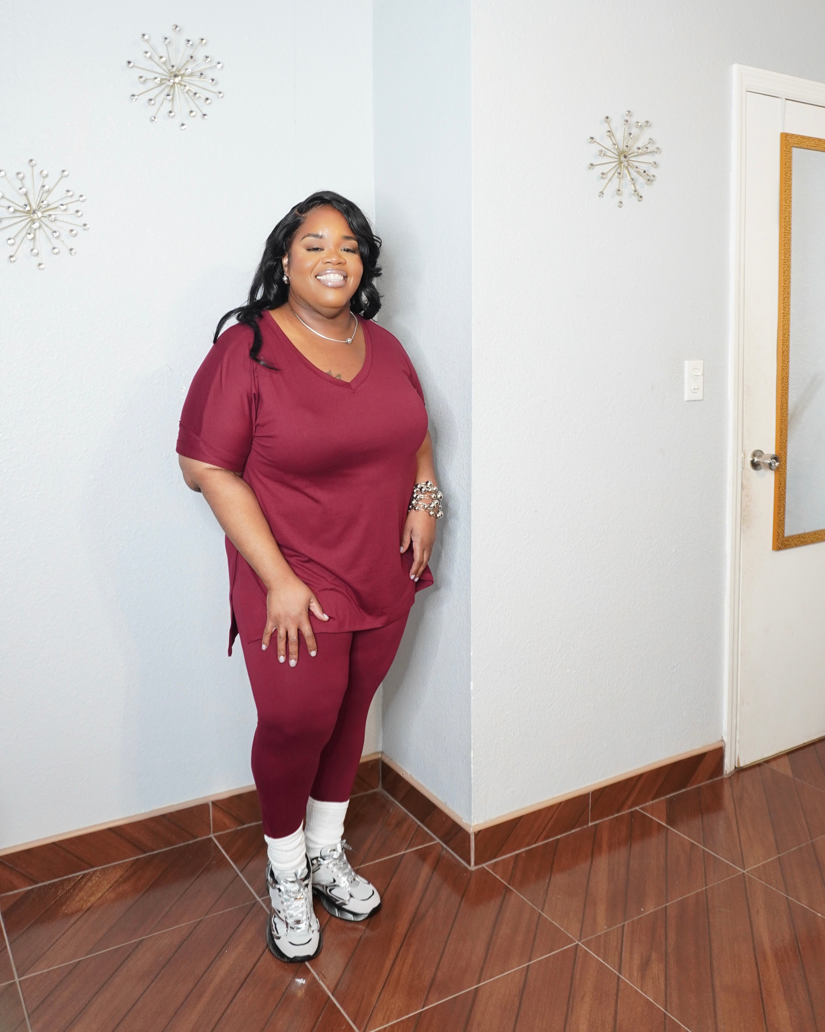 Front angled view of plus size two piece legging set with V-neck top